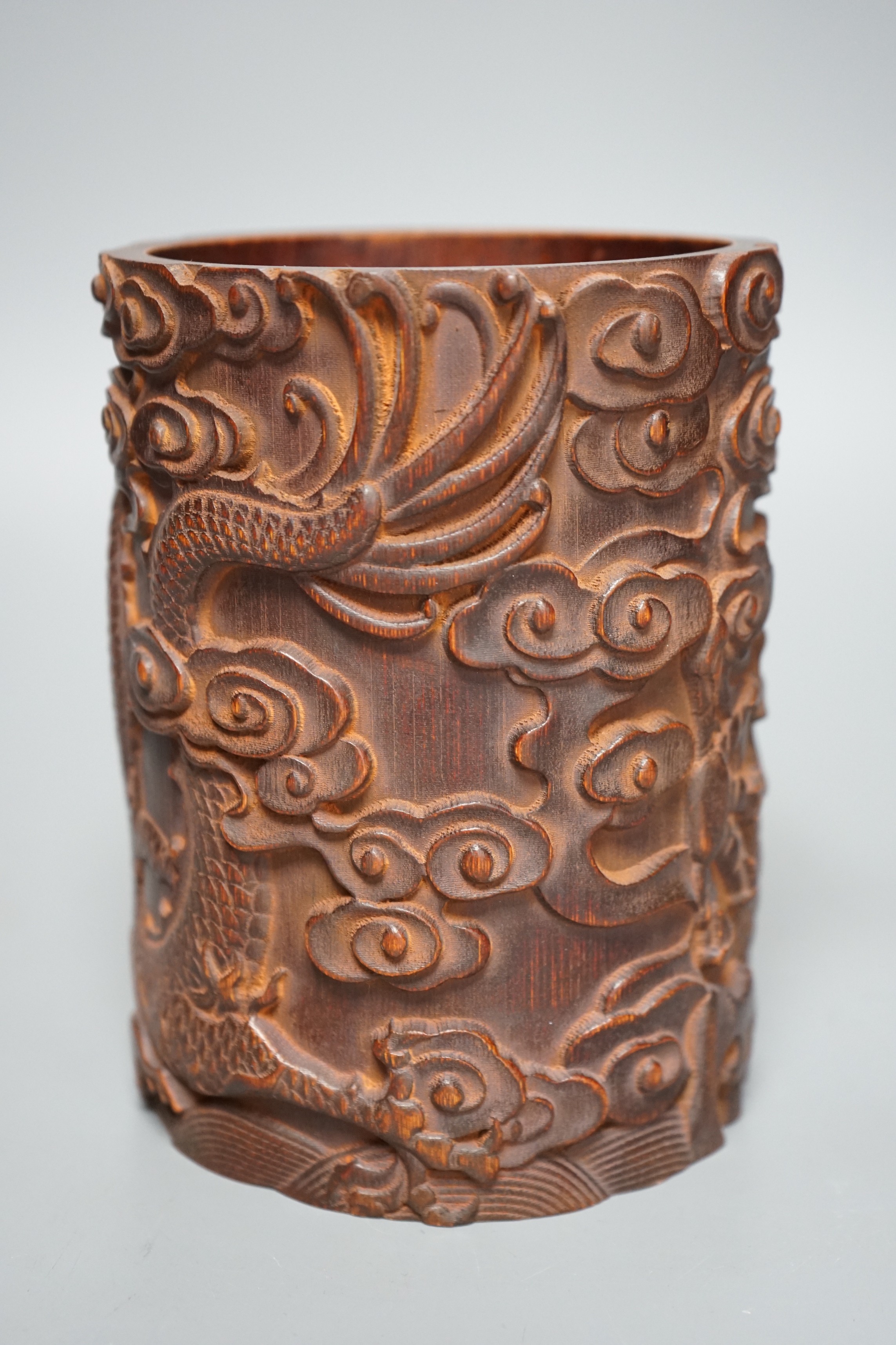 A Chinese ‘dragon’ carved bamboo brushpot, 17cm